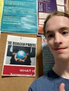 Me with a flyer for the Borgen Project I posted