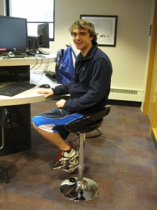 Student Joe Boino tests out one of the new computer stools on the Library's second floor. 