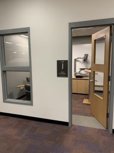 Video Recording Group Study Room "J" with seating, a computer, and podium.