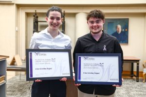 Research Prize Winners Ashley Dugasz and E Kerr holding framed certificates.