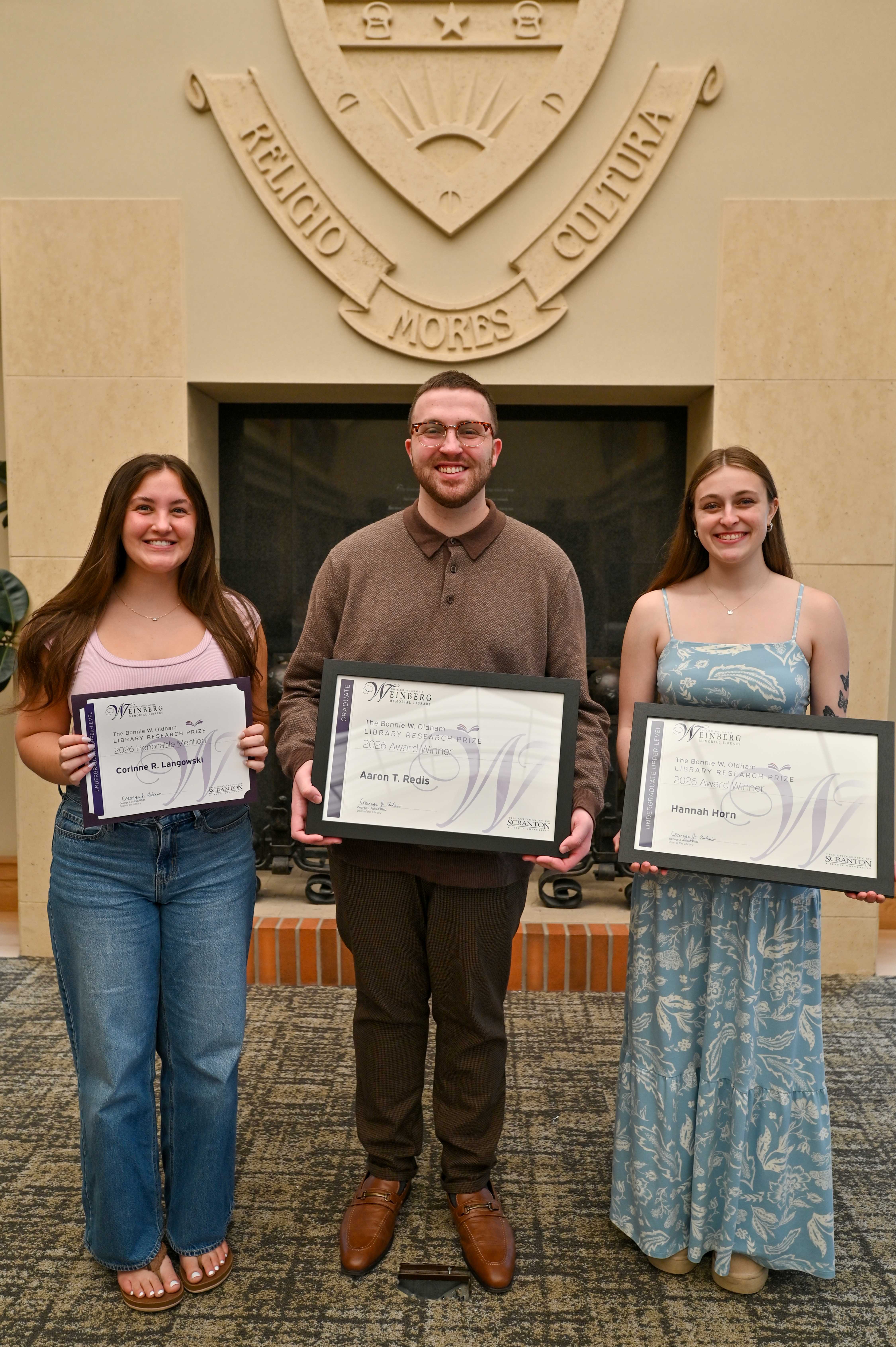 Research Prize honorees holding frames certificates.